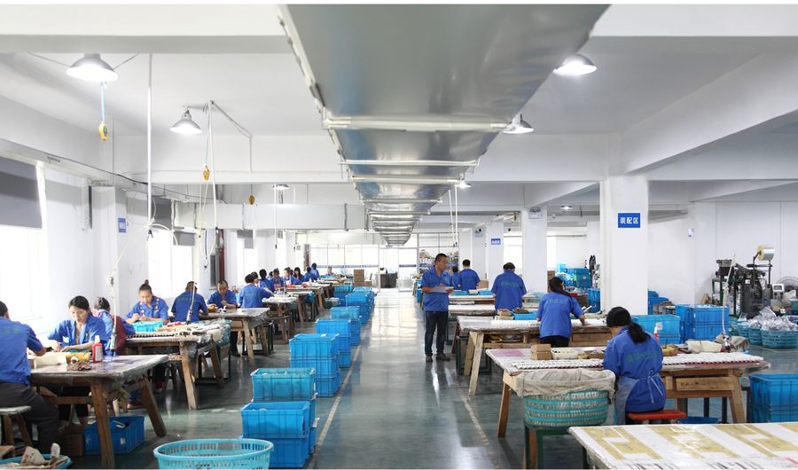 Assembly line at the Ouzhilun plant, with staff fitting handles and lock boxes